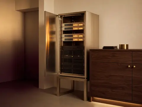 Warm-lit systems lab with a server rack and amber network lights